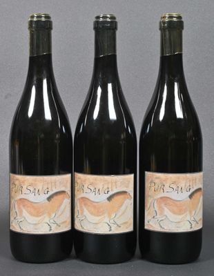 three bottles of wine sitting next to each other on a table
