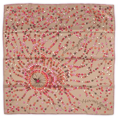 a beige scarf with pink and red flowers on it