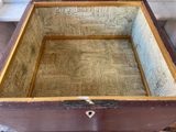 a wooden box with a lid that has a pattern on it