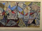 painting of abstract shapes in a frame on a wall