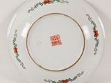 an image of a white plate with red flowers on it