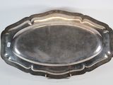 a silver tray on a white table with a silver handle