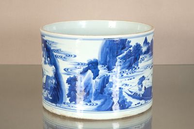 a blue and white cup sitting on a table