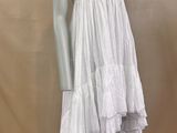 a mannequin with a white dress on a mannequin base