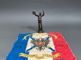a small statue of a man holding a flag on a table