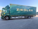 a green truck that is parked in a parking lot