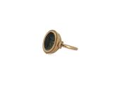 a close up of a gold ring with a green stone