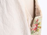 the back of a woman ' s dress with a floral design on it