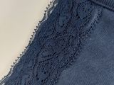 a close up of the back of a blue top with lace on it