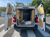 a white van with its doors open on the street