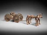une image représentant une figurine de cheval tirant une charrette