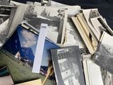 a pile of old black and white photos on a table