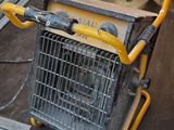 a yellow and black cart sitting on the floor in a garage