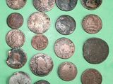 a lot of coins that are on a green surface