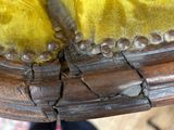 a close up of a person ' s feet on a yellow chair