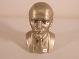 a gold bust of a man with a tie on
