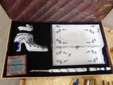 a box with a pair of high heel shoes and a pen