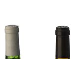 two bottles of wine sitting next to each other on a table