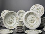 many plates and cups that are sitting on a table