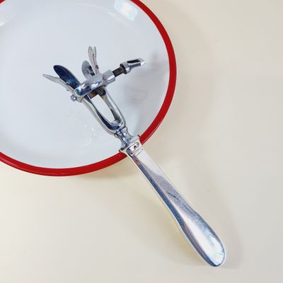 a red and white plate with a fork and spoon on it