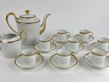 a lot of cups and saucers sitting on a table