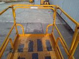a yellow platform with a yellow handrail on it