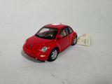a small red toy car with a white tag on it