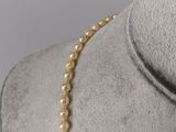 a close up of a necklace on a mannequin mannequin