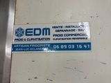 a sticker on the door of a building that says edm