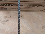 a box of tools sitting on the floor next to a pile of boxes