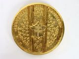 an image of a gold coin with a picture of a man on it