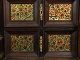 a wooden cabinet with a floral design on the doors