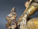 bronze statue of a person riding a horse with a bird on its back