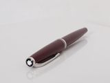 a close up of a pen sitting on top of a white surface