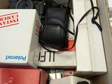 a box with a camera, a cell phone, and other items in it