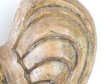 a wooden sculpture of a heart on a white surface
