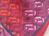 pink and red scarf with geometric design on a white background