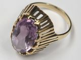 an image of a gold ring with a large amethorate stone