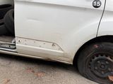 a white van that is parked on the side of the street