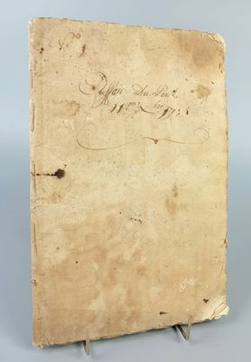 an old book with writing on it sitting on a table