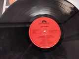 a black record with a red label sitting on a table