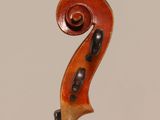 an old violin with a long neck and a long bow