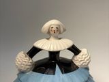 a blue and white vase with a woman in it