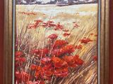 une peinture à l'huile d'un champ de coquelicots rouges dans un cadre doré