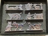 a metal tray that has a bunch of metal animals on it