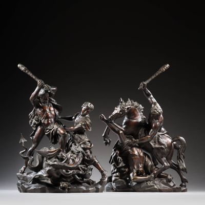 two bronze statues of a man and a woman on horseback