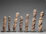 a group of carved wooden figurines of different shapes and sizes