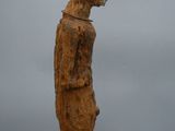 an old wooden statue of a man with a hat on his head