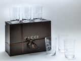 four glasses in a box with a ribbon around them