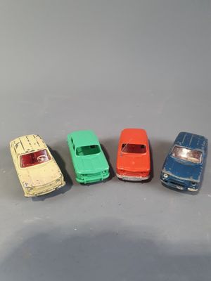 several toy cars are lined up in a row on a gray surface